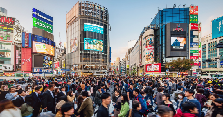 Shibuya Crossing with Yamanote Line train in the background